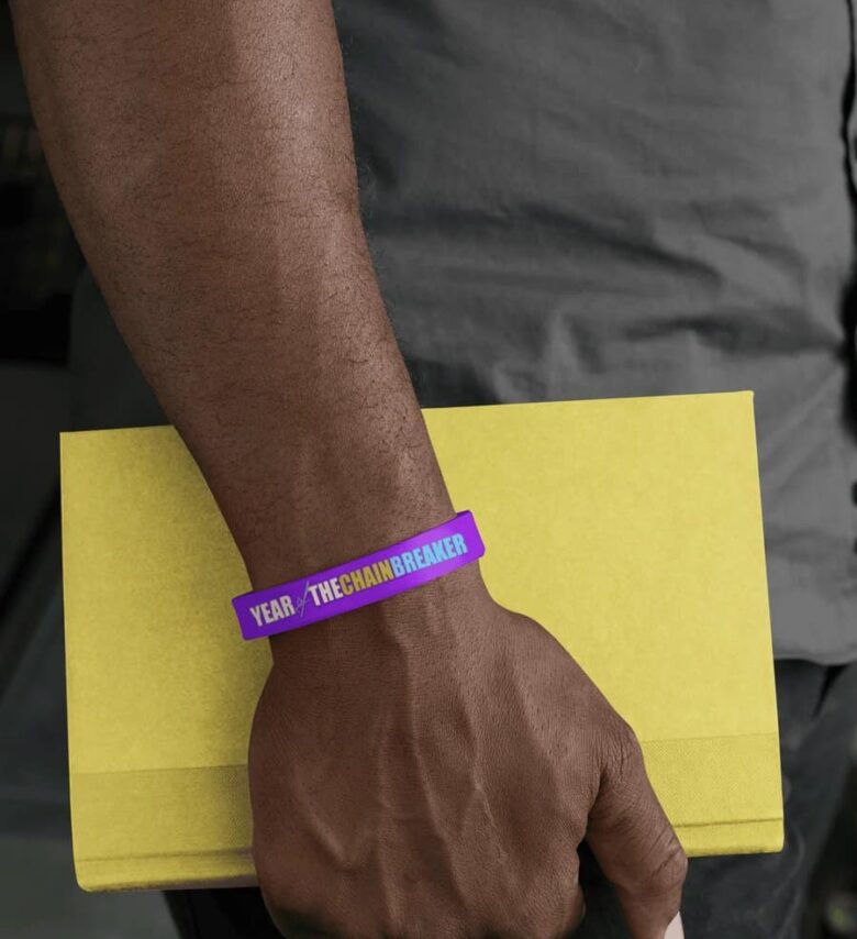 silicone-wristband-mockup-of-a-man-holding-a-book-28233.jpeg